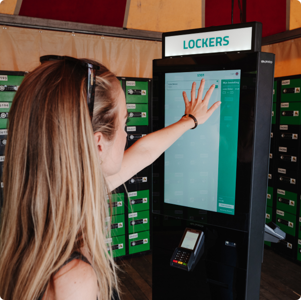 A woman touches the order column screen of lockers